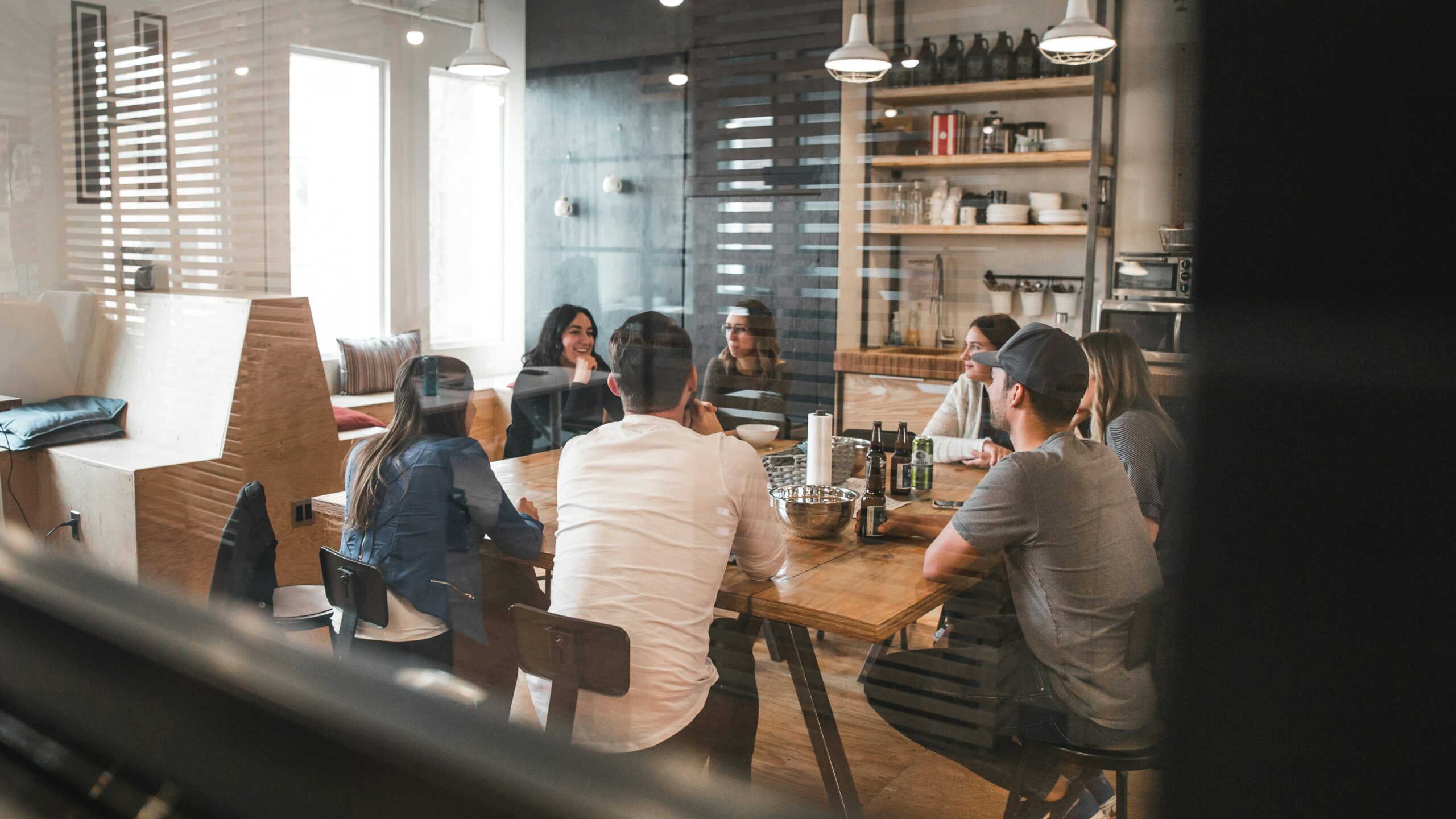 Photo of people sitting around a conference table by Redd F on Unsplash
